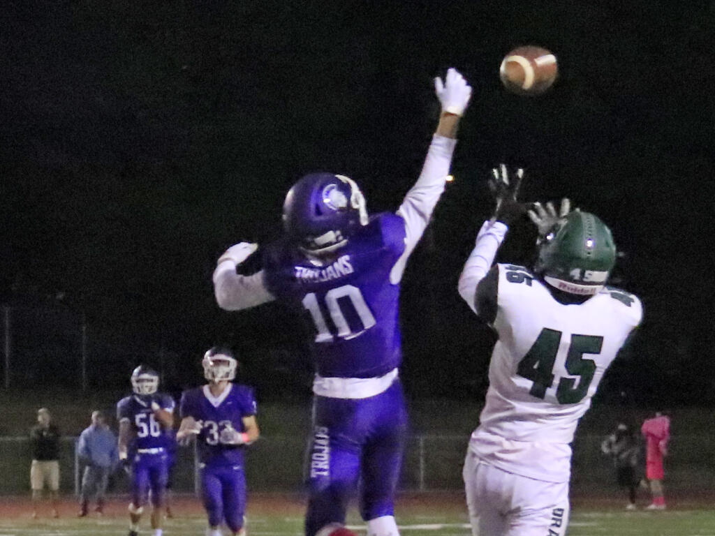 Joey Fiorito (45) tipped the ball away from Trojan defender Doren Shaw (10) to make the third-quarter catch that gave the Dragons a welcome first down on a 4th and 20 play. Sonoma Valley lost to Petaluma, 37-13 in Petaluma, Oct. 15, 2021. (Christian Kallen/Index-Tribune)