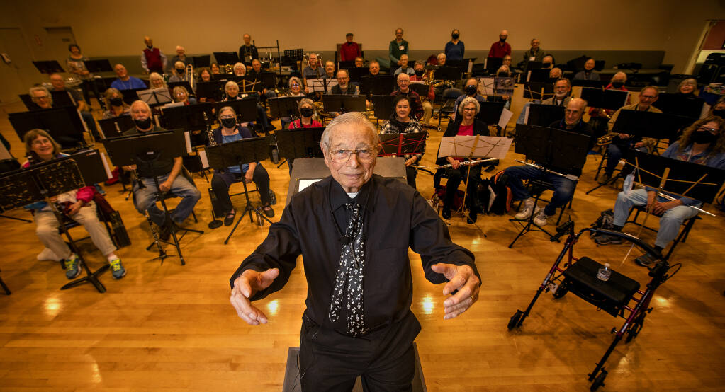 Longtime member of the New Horizons Band, Sid Gordon took the podium to conduct the senior orchestra on his 95th birthday at the Oddfellows Hall in Santa Rosa on Tuesday Dec. 7, 2021. (John Burgess / The Press Democrat)