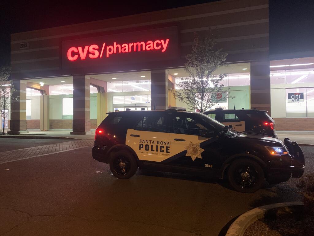 Santa Rosa police vehicles are visible outside the CVS pharmacy on Mendocino Avenue Thursday, March 17, 2022. Police say a suspect robbed the store but was arrested after a chase ending in Petaluma. (Colin Atagi/The Press Democrat)