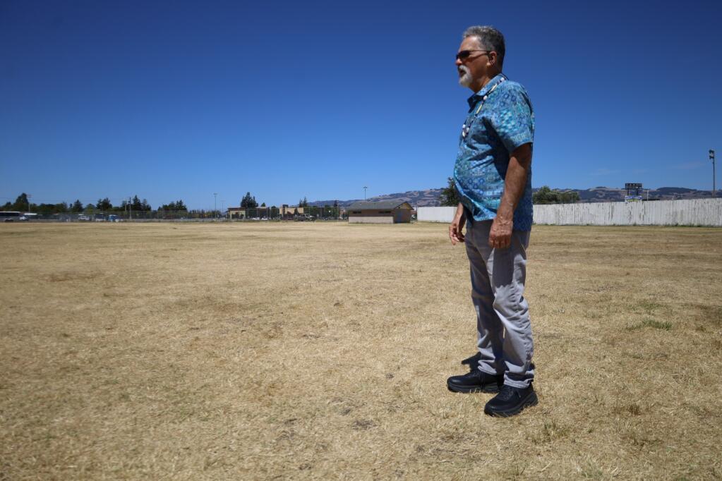 Joe Sanchez stands on Fairgrounds. Hills, where his ancestral village was likely located, are visible in the background. “Our ancestors were here since time immemorial,” he says. (PHOTO BY LINA HOSHINO/ARGUS-COURIER COLUMNIST)