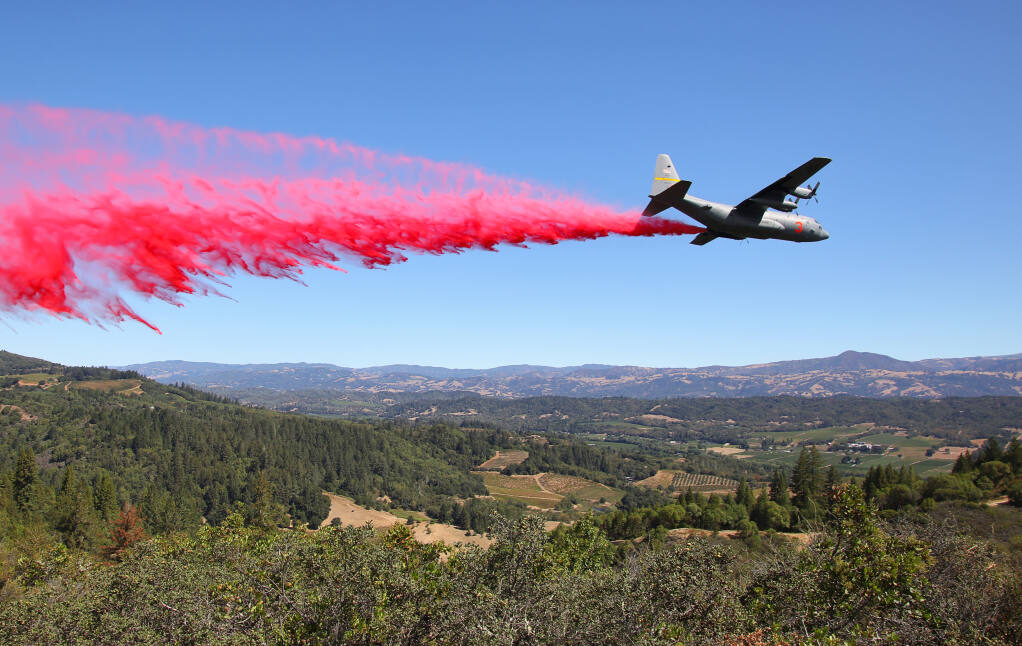 An air tanker drops retardant along Chemise Road, in the hills west of Healdsburg above the Dry Creek Valley on Friday, Aug. 21, 2020.  (Christopher Chung/ The Press Democrat)