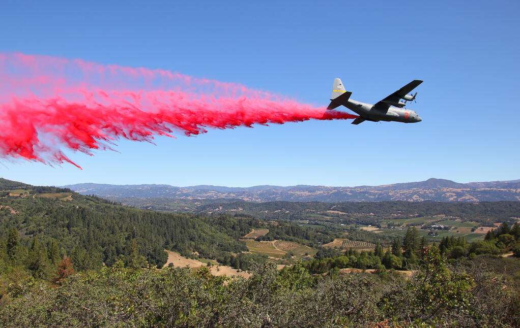An air tanker drops retardant along Chemise Road, in the hills west of Healdsburg above the Dry Creek Valley on Friday, Aug. 21, 2020.  (Christopher Chung/ The Press Democrat)