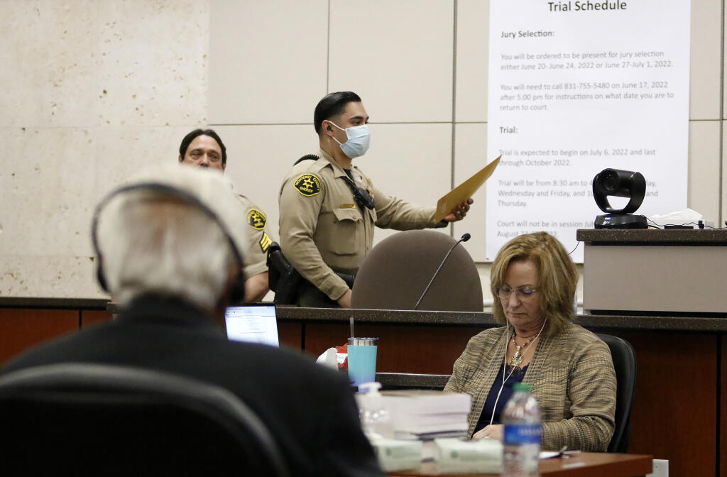 A bailiff hands the judge an envelope from the jury during Ruben Flores' trial in Monterey County Superior Court on Tuesday, Oct. 18, 2022, in Salinas, Calif. The jury acquitted Flores of helping his son, Paul Flores, cover up the murder of Cal Poly student Kristin Smart. (Laura Dickinson/The Tribune via AP, Pool)
