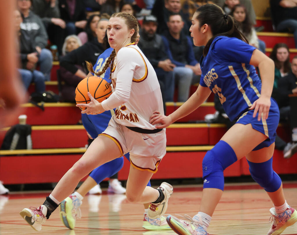 Cardinal Newman’s Abbie Mullins drives the lane against Clovis during their playoff game in Santa Rosa on Thursday, March 2, 2023. (Christopher Chung/The Press Democrat)