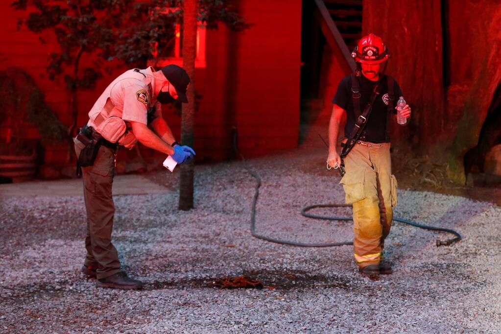 A Sonoma County sheriff’s deputy photographs evidence at the scene of an explosion that injured multiple people in Rio Nido on Tuesday, Aug. 4, 2020. (Alvin A.H. Jornada / The Press Democrat)