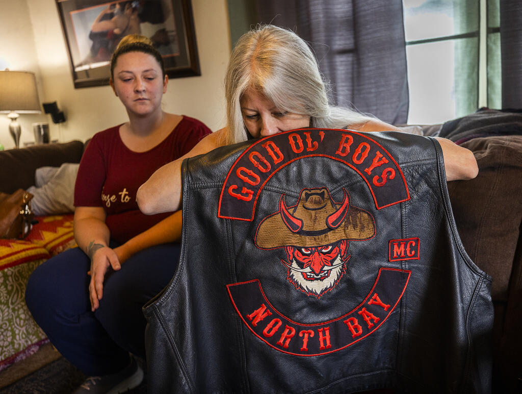 Cari Ogden, the wife of Curt Ogden, who died last week in a motorcycle crash, hugs the vest he was wearing while his daughter, Cheyanne Ogden, tells stories of his life in their Cotati home on Friday, March 25, 2022.  (John Burgess/The Press Democrat)