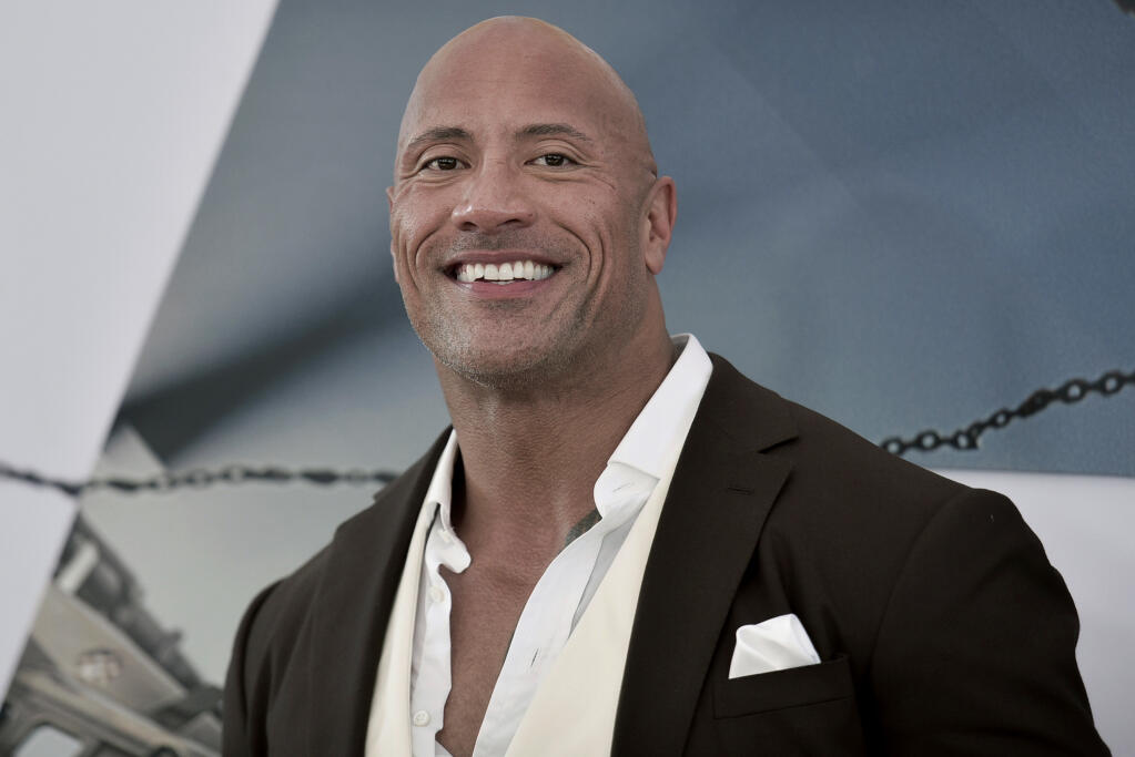FILE - Dwayne Johnson attends the premiere of "Fast & Furious Presents: Hobbs & Shaw" on July 13, 2019, in Los Angeles. Johnson said he has acquired the XFL. The 48-year-old actor made the announcement on Twitter. Reportedly the price is $15 million. The XFL had eight franchises and played five games out of a planned 10-game schedule before canceling the remainder of its season in March because of the COVID-19 pandemic.Â (Photo by Richard Shotwell/Invision/AP, File)