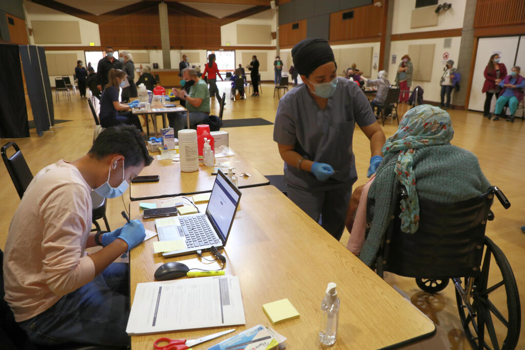 FILE — A coronavirus vaccine is administered at a vaccination center in Rohnert Park, Calif., Jan. 27, 2021. Federal officials on Sept. 15, 2021, ranked the state’s current coronavirus case rate the lowest in the nation. (Jim Wilson/The New York Times)