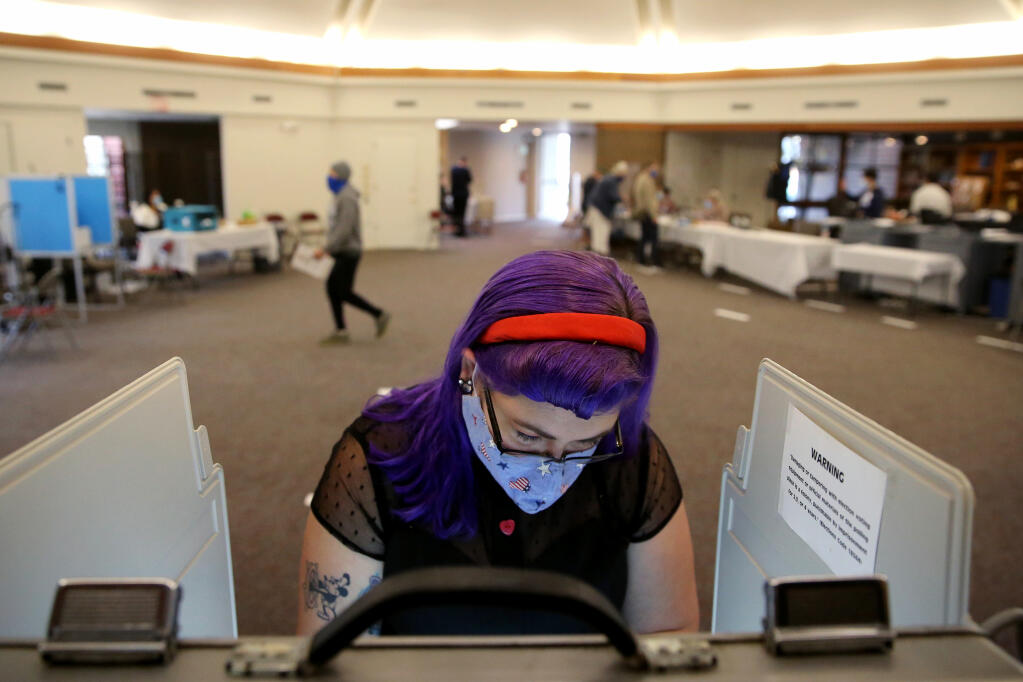 Jacey Ohlinger fills out her ballot at the polling location at Christ Church United Methodist in Santa Rosa on Tuesday, Nov. 3, 2020.  (Beth Schlanker/ The Press Democrat)