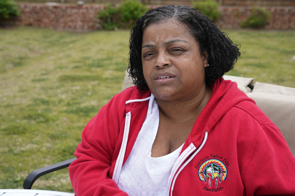 LeEtta Osborne-Sampson is pictured outside her home Monday, April 26, 2021, in Oklahoma City. Sampson-Osborn, a Seminole Freedman who has a tribal identification card and serves on the tribe's governing council, said when she went to the Indian Health Services clinic to get a vaccination in February, a worker at the clinic told her the Seminole Nation doesn't recognize Freedmen for health services. (AP Photo/Sue Ogrocki)