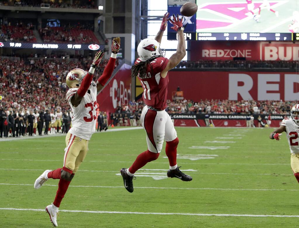 Arizona Cardinals wide receiver Larry Fitzgerald pulls in the game-winning touchdown as San Francisco 49ers cornerback Rashard Robinson defends during overtime, Sunday, Oct. 1, 2017, in Glendale, Ariz. The Cardinals won 18-15. (AP Photo/Rick Scuteri)