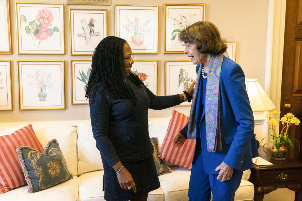 FILE - Sen. Dianne Feinstein, D-Calif., greets Supreme Court nominee Judge Ketanji Brown Jackson, left, in her hideaway office at the Capitol, Wednesday, March 16, 2022, in Washington. Feinstein announced Tuesday, Feb. 14, 2023, that she will not seek reelection in 2024, signaling the end of a groundbreaking political career spanning six decades. Feinstein said in a statement that she intended to remain in Congress through the end of her term. (AP Photo/Manuel Balce Ceneta, File)