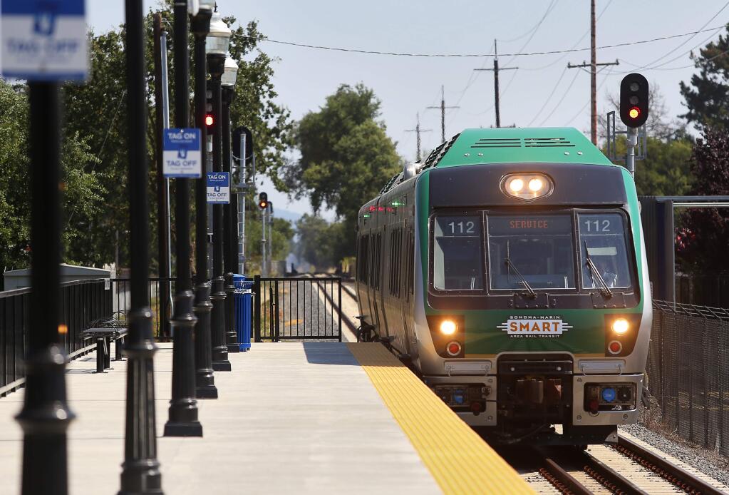 A SMART train on a test run pulls into the Sonoma County Airport platform along Airport Boulevard in Santa Rosa on Thursday, Aug. 17, 2017. (Christopher Chung / The Press Democrat file)