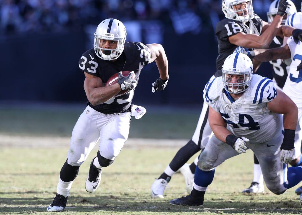 Oakland Raiders running back DeAndre Washington runs the ball for a touchdown against the Indianapolis Colts, during their game in Oakland on Saturday, December 24. (Christopher Chung/ The Press Democrat)