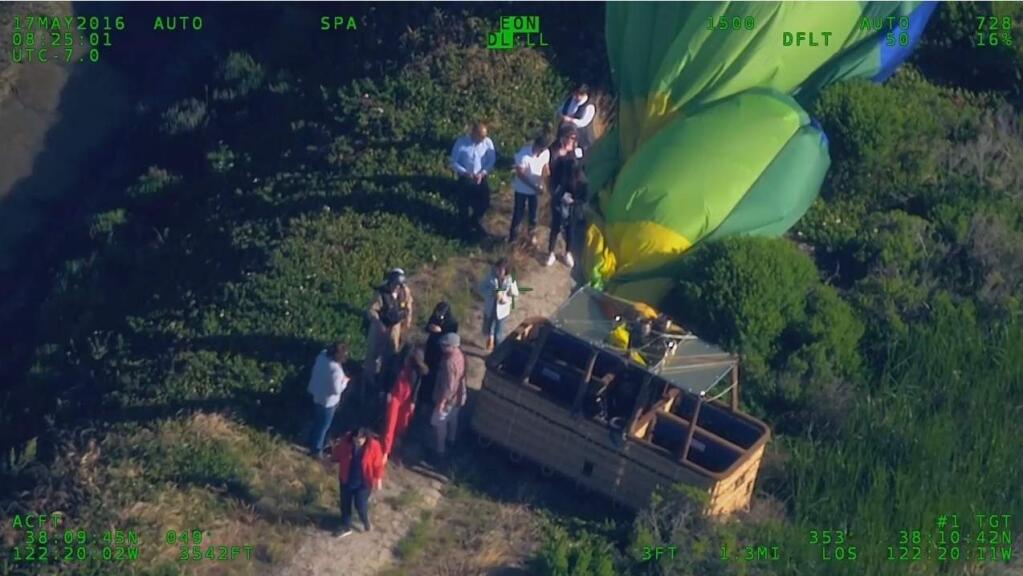 Image from an aerial video showing the rescue of the passengers and pilot of a grounded hot air balloon in a Napa-area marsh Tuesday. (CHP)