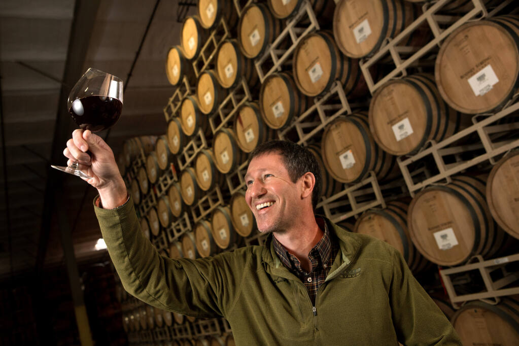 Greg Morthole, Rodney Strong winemaker, looks at one of his Davis Bynum brand wines, In the barrel room at Rodney Strong's winery, Wednesday, Dec. 28, 2022, in Healdsburg. (Darryl Bush / For The Press Democrat)