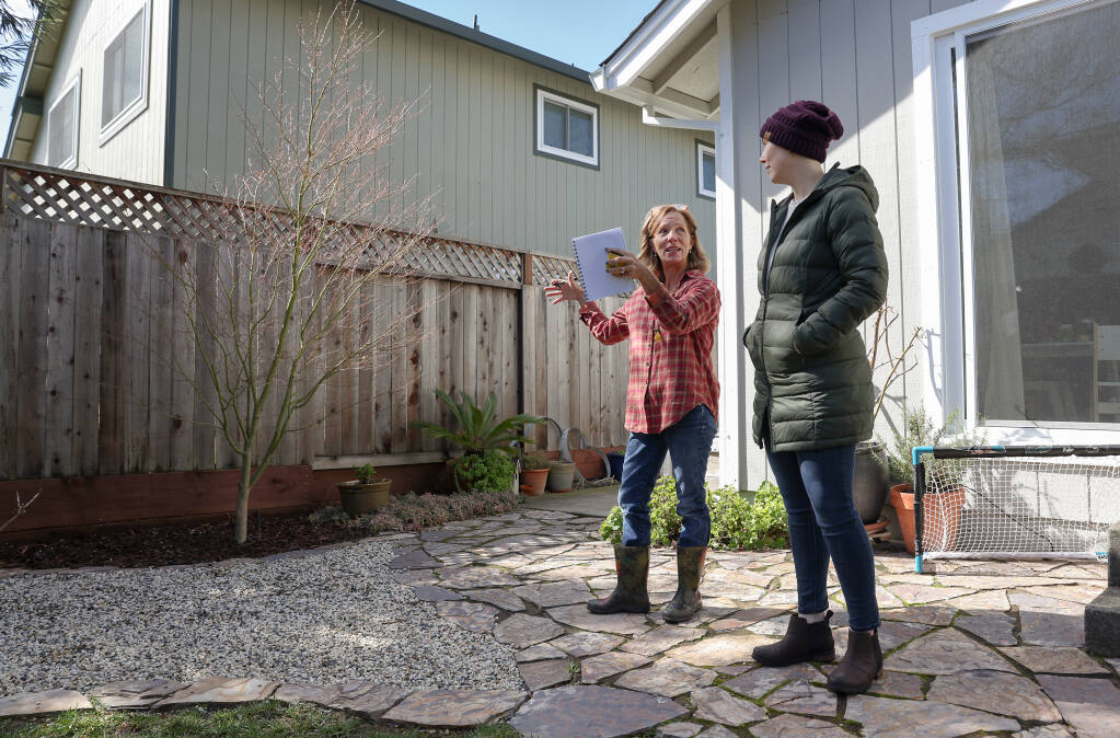 Anne-Marie Allen, owner of Allen Land Design and founder of Deep Breath Healing Gardens, left, plans a garden space with client Tara Johnson in Santa Rosa, Wednesday, March 1, 2023. (Christopher Chung / The Press Democrat)