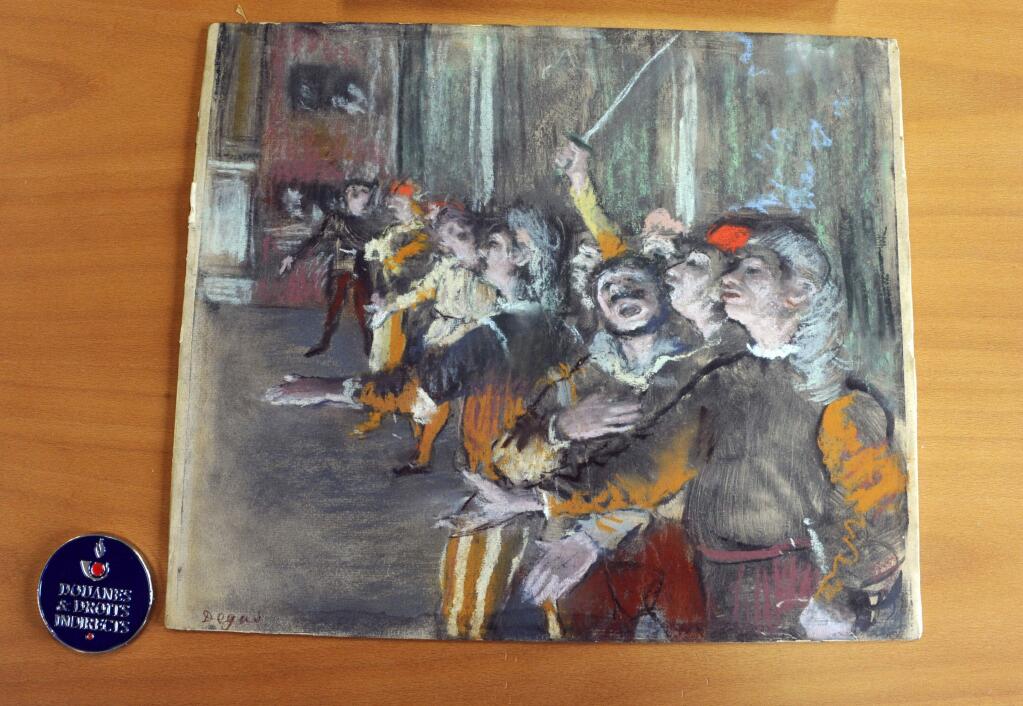 This photo taken Thursday Feb. 22, 2018 and provided by French Customs shows a stolen painting by French painter Edgar Degas. French customs have discovered an original Impressionist masterpiece by Edgar Degas stolen in 2009 _ in a suitcase on a bus. (Marc Bonodot/French Customs via AP)