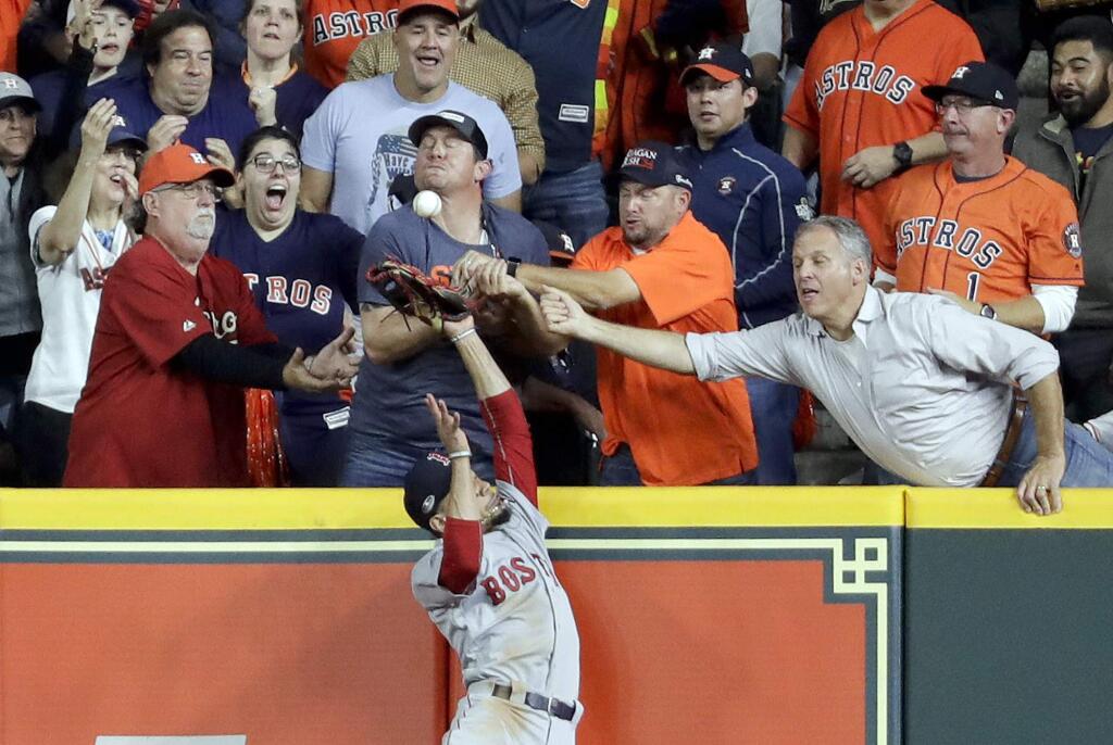 Fans interfere with Boston Red Sox right fielder Mookie Betts trying to catch a ball hit by Houston Astros' Jose Altuve during the first inning in Game 4 of the American League Championship Series on Wednesday, Oct. 17, 2018, in Houston. Altuve was called out. (AP Photo/Frank Franklin II)
