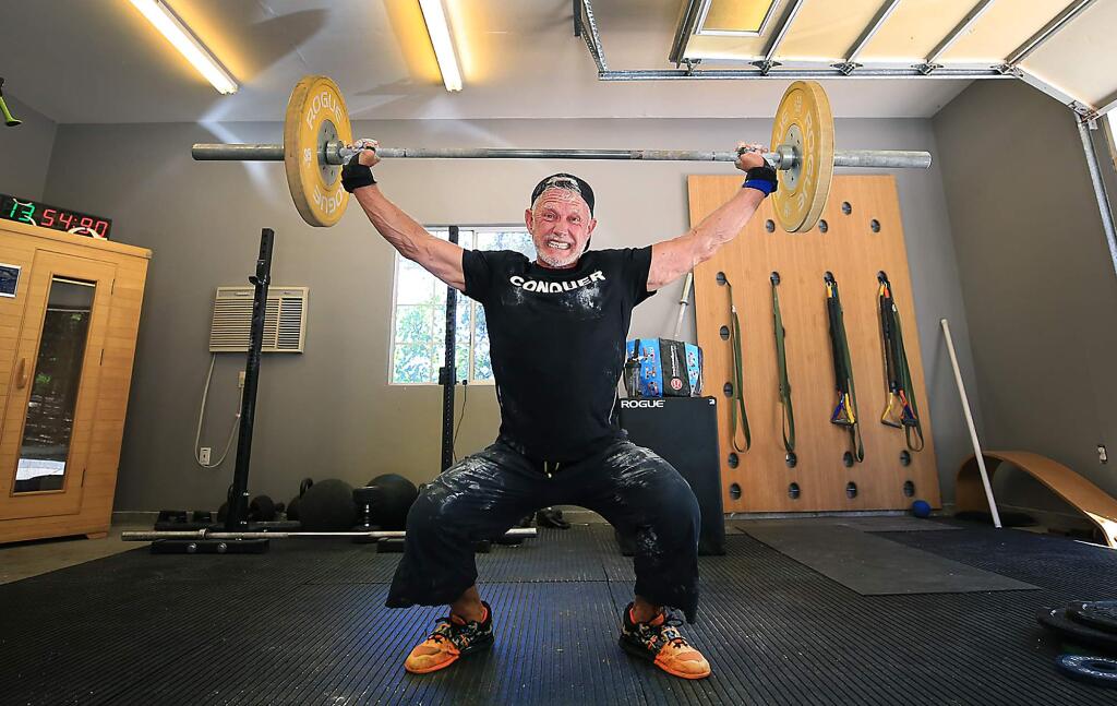 Joe Stumpf practices the clean and jerk in Forestville on Monday. Stumpf is one of only 20 people over 60 that qualified for the CrossFit Games in Madison, Wisconsin, later this summer. Stumpf moved from San Diego to Forestville primarily to train for the games. (Kent Porter / Press Democrat)