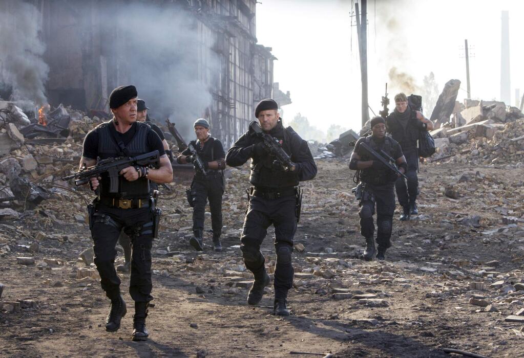 This image released by Lionsgate shows Sylvester Stallone, left, and Jason Statham, center, in a scene from 'Expendables 3.' (AP Photo/Lionsgate, Phil Bray)