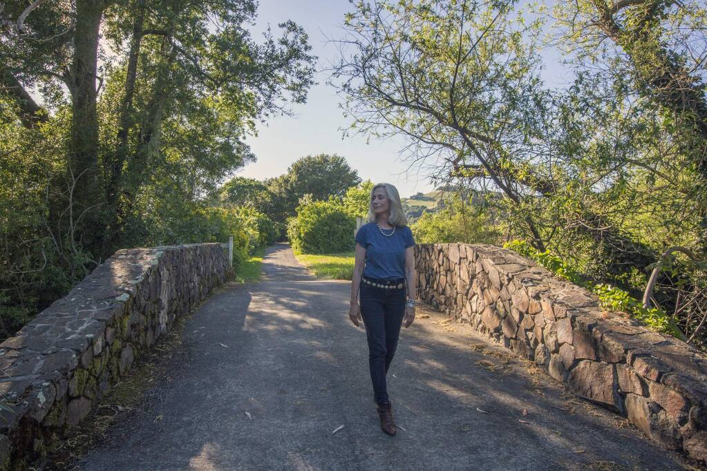 Anna Pope, the trustee of the Frank H. Bartholomew Foundation, walks along one of the trails that are now open to hikers at the Sonoma winery and museum estate. (Photo by Robbi Pengelly/Index-Tribune)