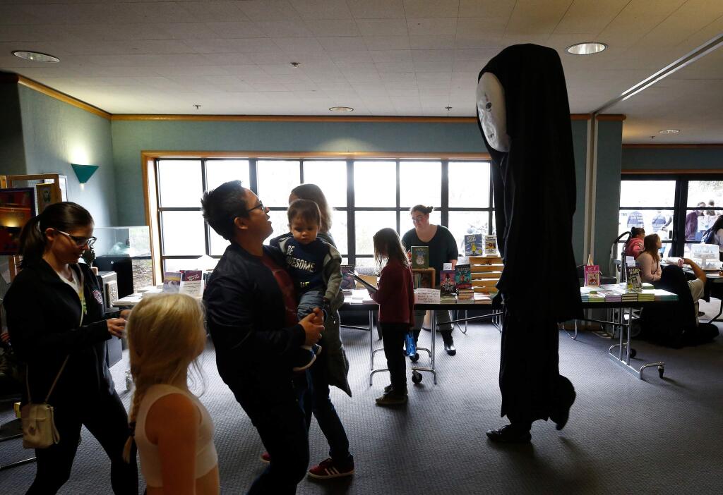 The towering costume of Japanese anime character No-Face from Spirited Away worn by Leo Galbraith, 15, of Sebastopol nearly touches the ceiling of the Lucchesi Center as he makes his way toward the costume competition during LumaCon in Petaluma, California, on Saturday, January 25, 2020. (Alvin Jornada / The Press Democrat)