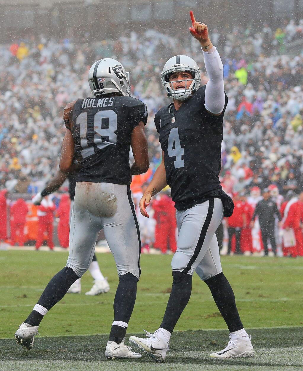 Oakland Raiders quarterback Derek Carr celebrates his first quarter touchdown pass to wide receiver Andre Holmes, during their game against the Kansas City Chiefs in Oakland on Sunday, October 16, 2016. The Raiders lost to the Chiefs 26-10. (Christopher Chung/ The Press Democrat)