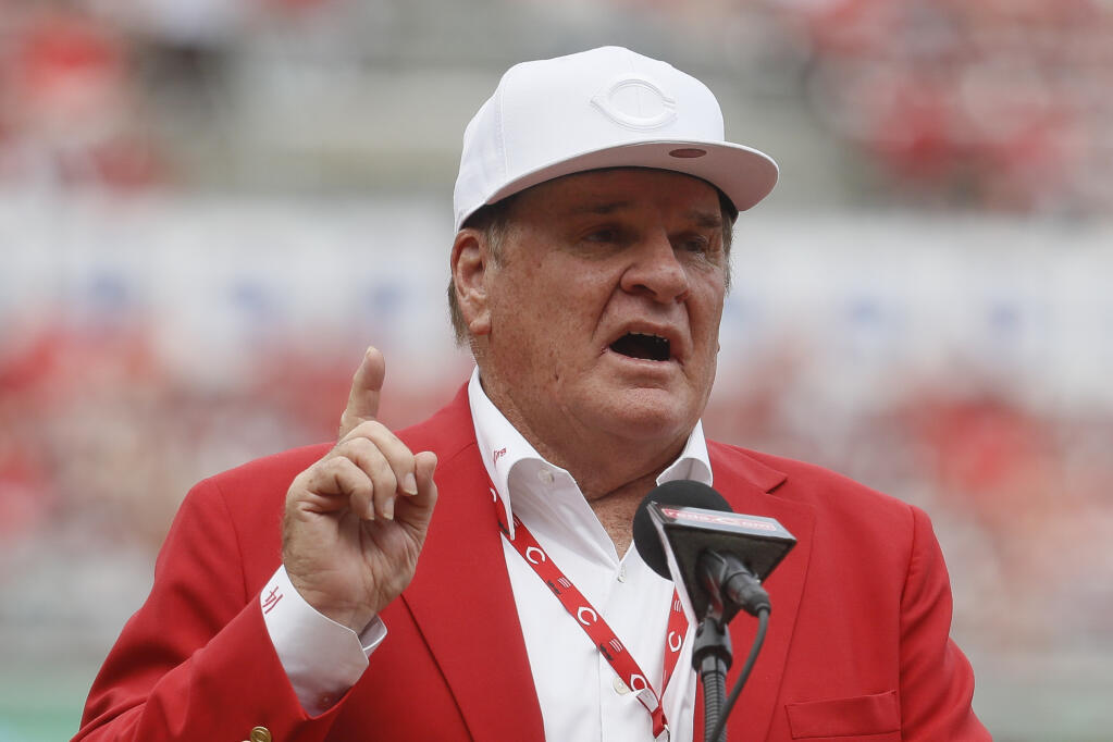 FILE -  Pete Rose speaks during a statue-dedication ceremony before a baseball game between the Cincinnati Reds and the Los Angeles Dodgers, June 17, 2017, in Cincinnati. Rose will make an appearance on the field in Philadelphia next month. Baseball’s career hits leader will be part of Phillies alumni weekend, and will be introduced on the field alongside many former teammates from the 1980 World Series championship team on Aug. 7.  (AP Photo/John Minchillo, File)