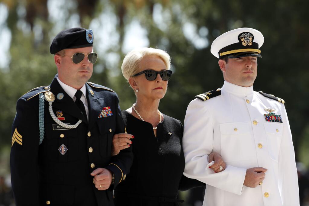 Cindy McCain arrives for a memorial service for Sen. John McCain, R-Ariz. at the Arizona Capitol on Wednesday, Aug. 29, 2018, in Phoenix, escorted by her sons Jimmy, left, and Jack. (AP Photo/Matt York)