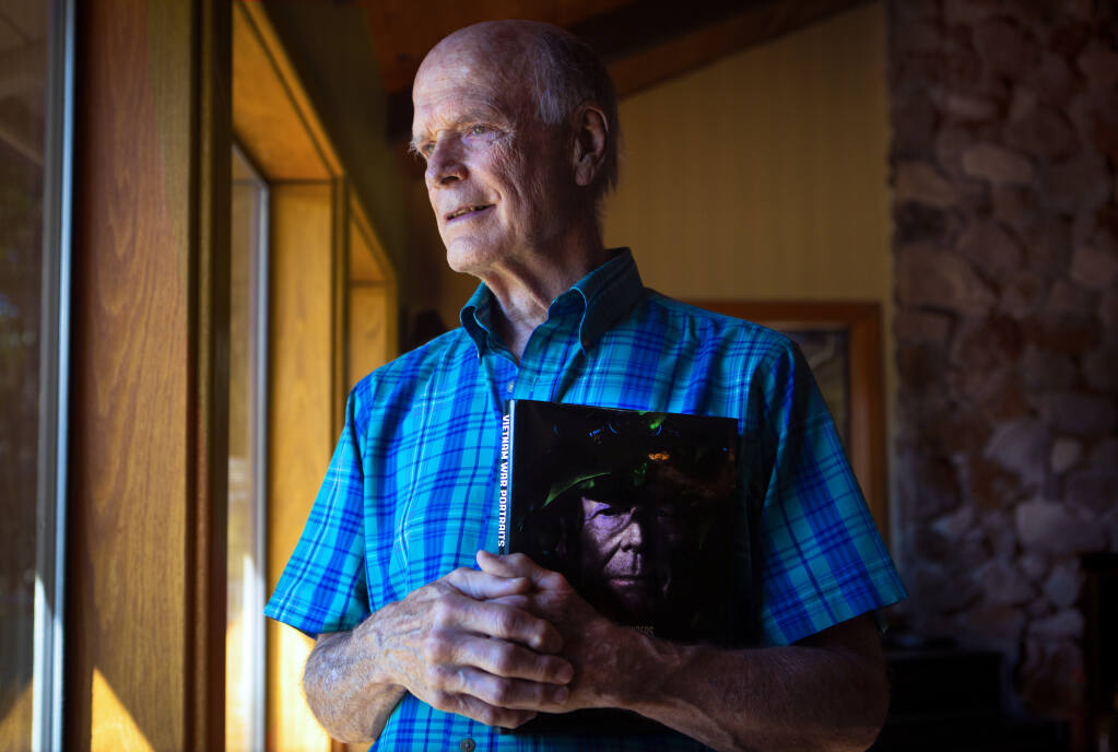 Robert Lyon at Lyon Ranch in Sonoma, with a copy of ’Vietnam War Portraits: The Faces and Voices.’ As a U.S. Navy pilot, Lyon flew more than 100 missions over North Vietnam. (Photo by Robbi Pengelly/Index-Tribune)