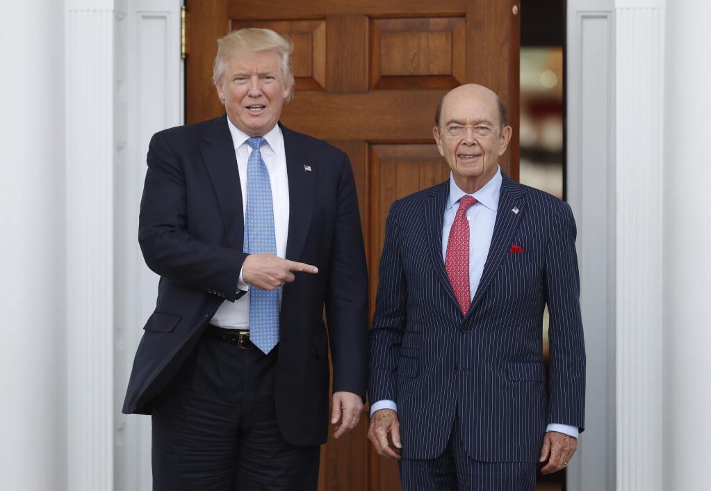 FILE - In this Sunday, Nov. 20, 2016, file photo, President-elect Donald Trump, left, stands with investor Wilbur Ross after meeting at the Trump National Golf Club Bedminster clubhouse in Bedminster, N.J. Trump is poised to offer the position of commerce secretary to the head of a private-equity firm, Wilbur Ross. (AP Photo/Carolyn Kaster)