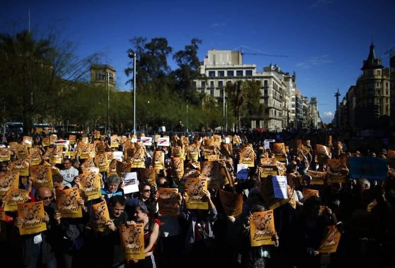 Demonstrators holding banners that read in Catalan 'Freedom for the Political Prisoners' during a protest at the University square in Barcelona, Spain Sunday.(AP Photo/Manu Fernandez)