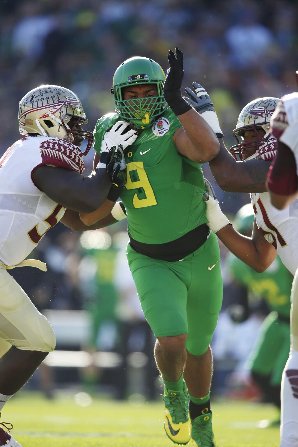 Oregon defensive lineman Arik Armstead (9) rushes against Florida State in the Rose Bowl college football playoff semifinal, Thursday, Jan. 1, 2015 in Pasadena. Oregon defeated Florida State 59-20 to advance to the first-ever NCAA football playoff championship game. (AP Photo/Doug Benc)