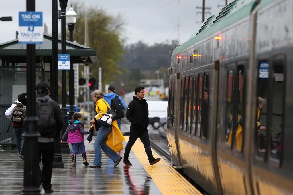 Passengers get on and off a southbound train at the SMART station in Petaluma on Tuesday, Feb. 26, 2019. (BETH SCHLANKER/The Press Democrat)