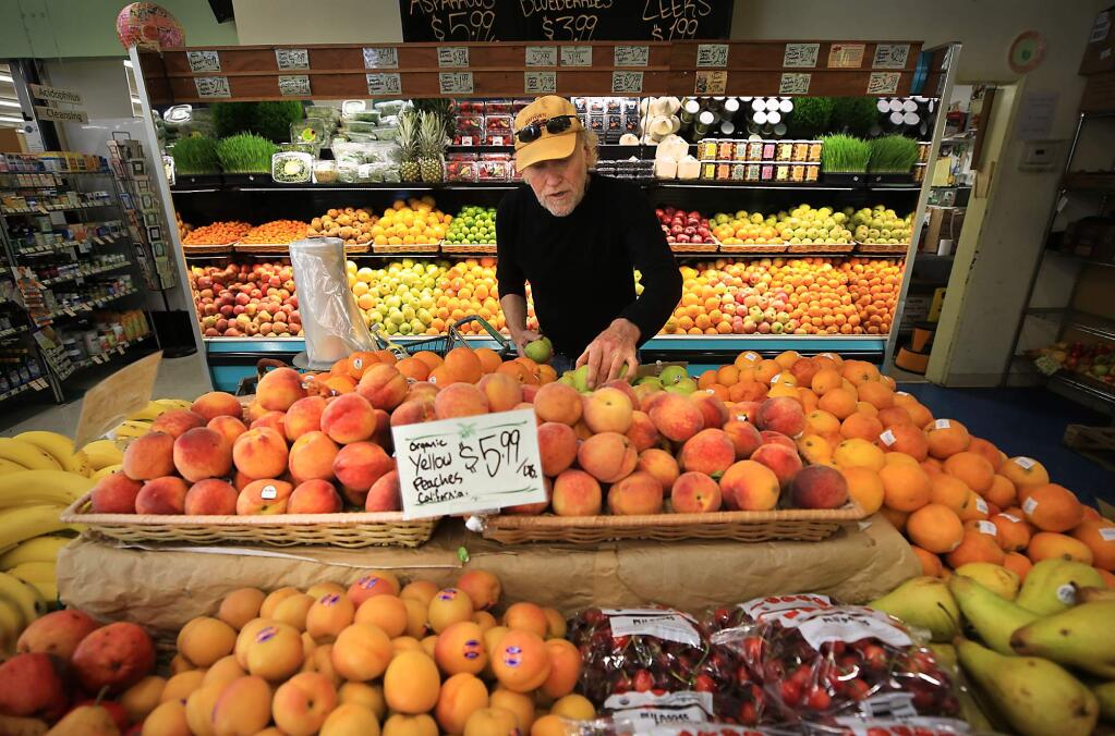 Rand Lind shops for organic produce at Community Market Natural Foods in Santa Rosa on Tuesday, May 9, 2017. (KENT PORTER/ PD)