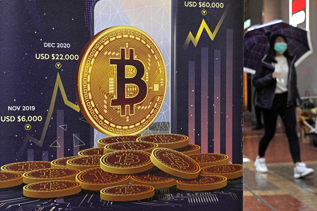 FILE - An advertisement for Bitcoin cryptocurrency is displayed on a street in Hong Kong, on Feb. 17, 2022.  (AP Photo/Kin Cheung, File)