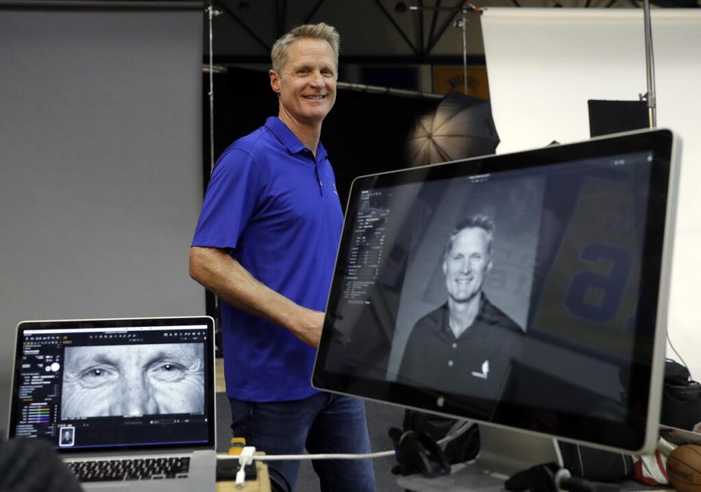 Golden State Warriors head coach Steve Kerr smiles after posing for photographs during NBA basketball team media day Friday, Sept. 22, 2017, in Oakland , Calif. (AP Photo/Marcio Jose Sanchez)