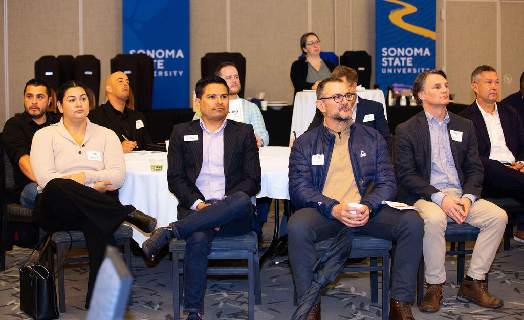 A group of attendees listen to the keynote speaker Alexander Sidorkin, Chief AI Officer & Director , National Institute on Artificial Intelligence in Education at the NBBJ Economic Outlook 2024 Summit held at Sonoma State University. Thursday, Feb. 29, 2024. (Photo by Charlie Gesell)