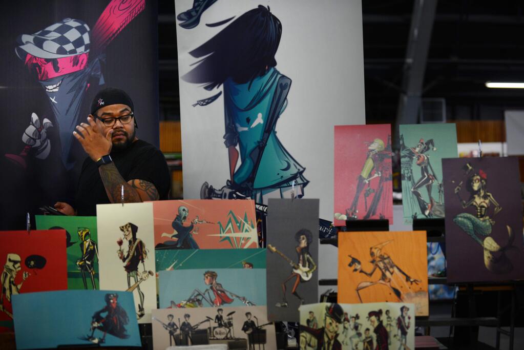Artist Hainanu Saulque of Sacramento, California surrounded by his works for sale during Toy & Comic Con 2016 held at The Sonoma County Fairgrounds, Saturday, September 24, 2016.(Photo: Erik Castro/for The Press Democrat)
