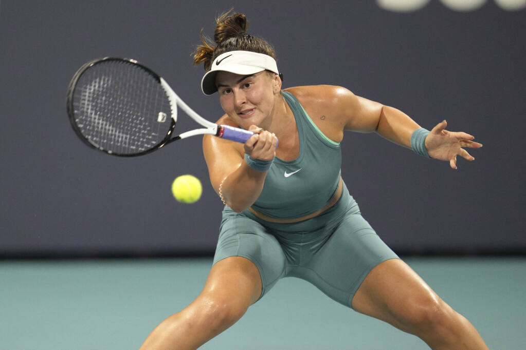 Bianca Andreescu, of Canada, returns a volley against Ekaterina Alexandrova, of Russia, in the first set of a match at the Miami Open tennis tournament, Monday, March 27, 2023, in Miami Gardens, Fla. (AP Photo/Jim Rassol)