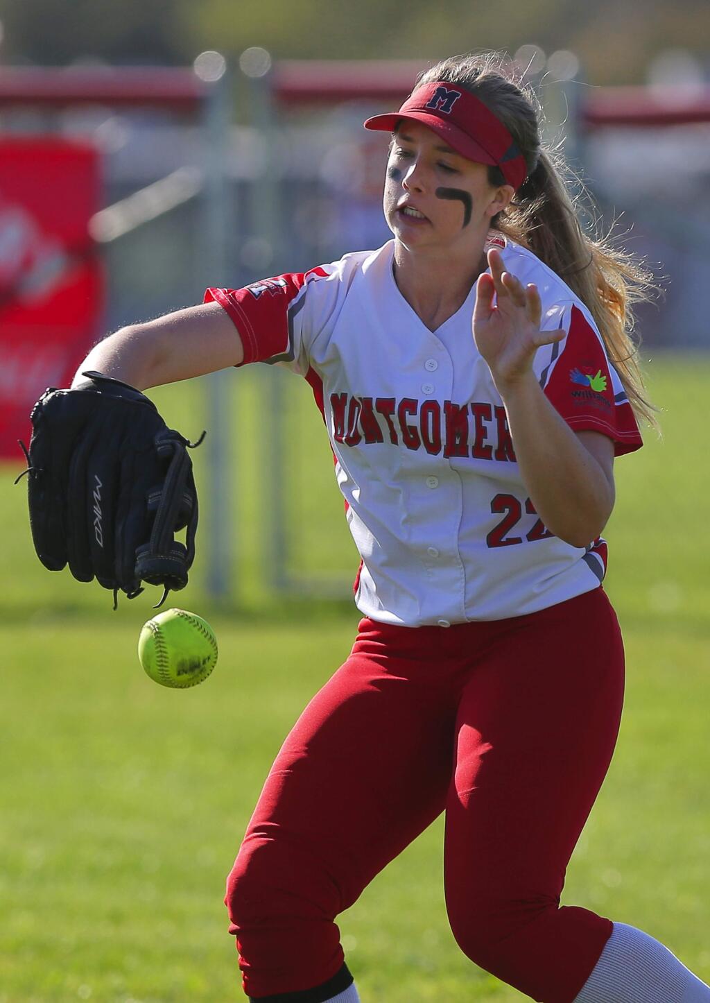 Montgomery's Madissen Larson drops a fly ball during a game against Cardinal Newman, in Santa Rosa on Thursday, March 29, 2018. (Christopher Chung/ The Press Democrat)