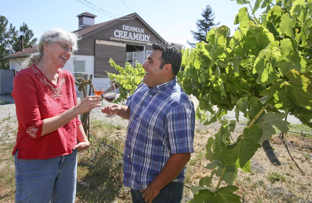 Laura Hagar Rush and P.W. Scoggins toast their new businesses in the vineyard at the historic Denman Creamery in Penngrove, which they share for Hagar Rush's Sonoma Aperitif and Scroggins's winery, on Tuesday, July 1, 2014. (Scott Manchester / Argus-Courier staff)