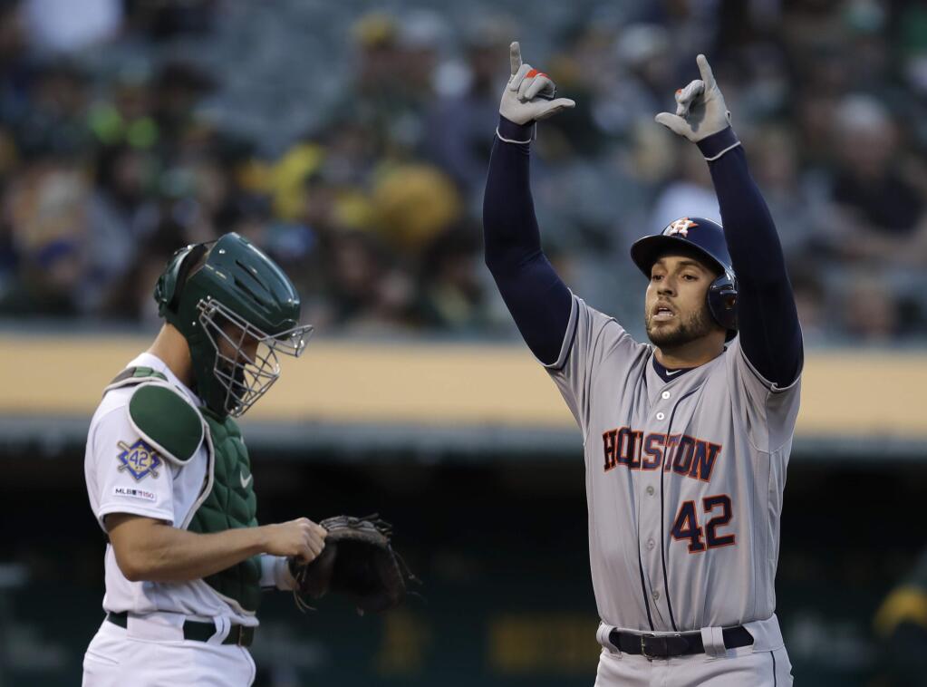 The Houston Astros' George Springer, right, celebrates after hitting a home run off the Oakland Athletics' Marco Estrada in the first inning, Tuesday, April 16, 2019, in Oakland. (AP Photo/Ben Margot)