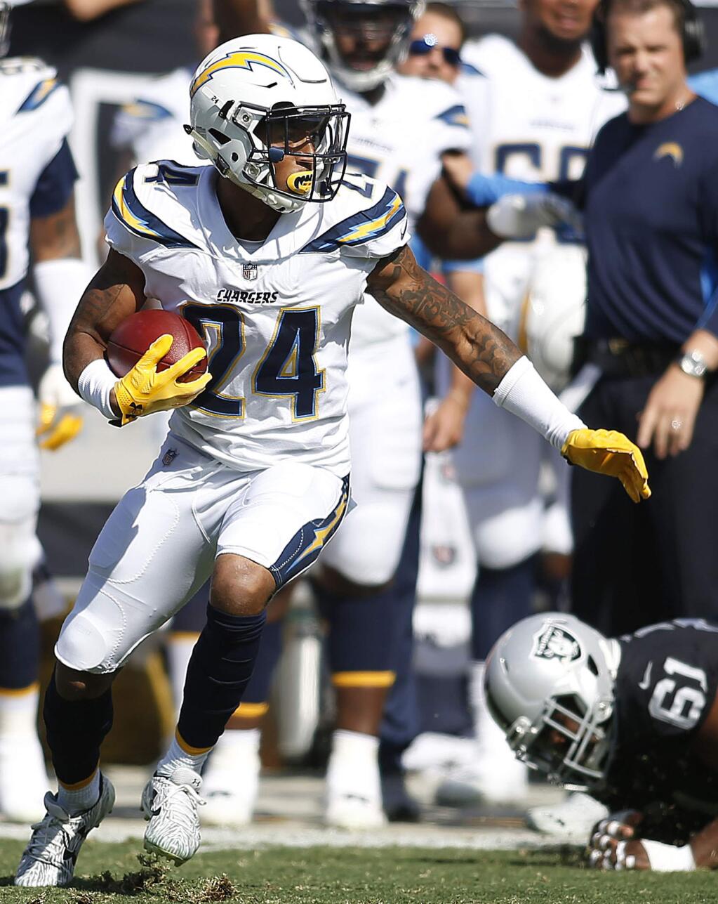 Los Angeles Chargers cornerback Trevor Williams (24) runs after intercepting a pass against the Oakland Raiders during the first half of an NFL football game in Oakland, Calif., Sunday, Oct. 15, 2017. (AP Photo/D. Ross Cameron)