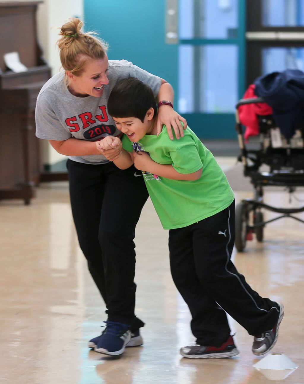 Education specialist Katya Robinson, left, plays with one of her former students, Jaxon Ono, during a physical education class at Park Side Elementary School in Sebastopol on Friday, October 11, 2019. (Christopher Chung/ The Press Democrat)