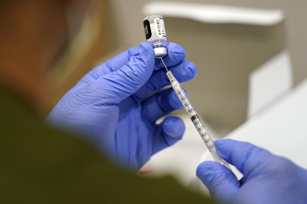 FILE — A health care worker fills a syringe with the Pfizer COVID-19 vaccine. (AP Photo/Lynne Sladky, File)