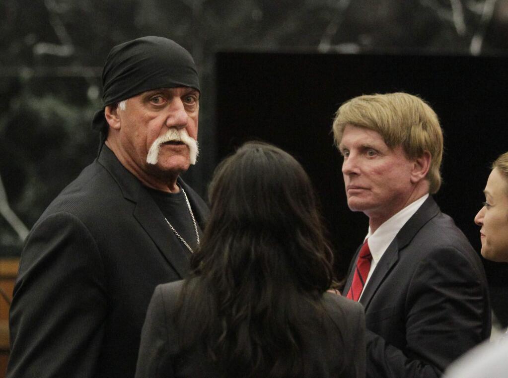 FILE - In this Monday, March 21, 2016, file photo, Hulk Hogan, whose given name is Terry Bollea, left, looks on in court moments after a jury returned its decision in St. Petersburg, Fla. (Dirk Shadd/The Tampa Bay Times via AP, Pool, File)