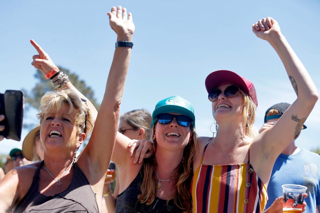 Karen Fields, left, Grace Kavanaugh and Ericka Lynn Buck sing along with The Sam Chase and the Untraditional during the Petaluma Music Festival at the Sonoma-Marin Fairgrounds in Petaluma, California, on Saturday, August 4, 2018. (Alvin Jornada / The Press Democrat)