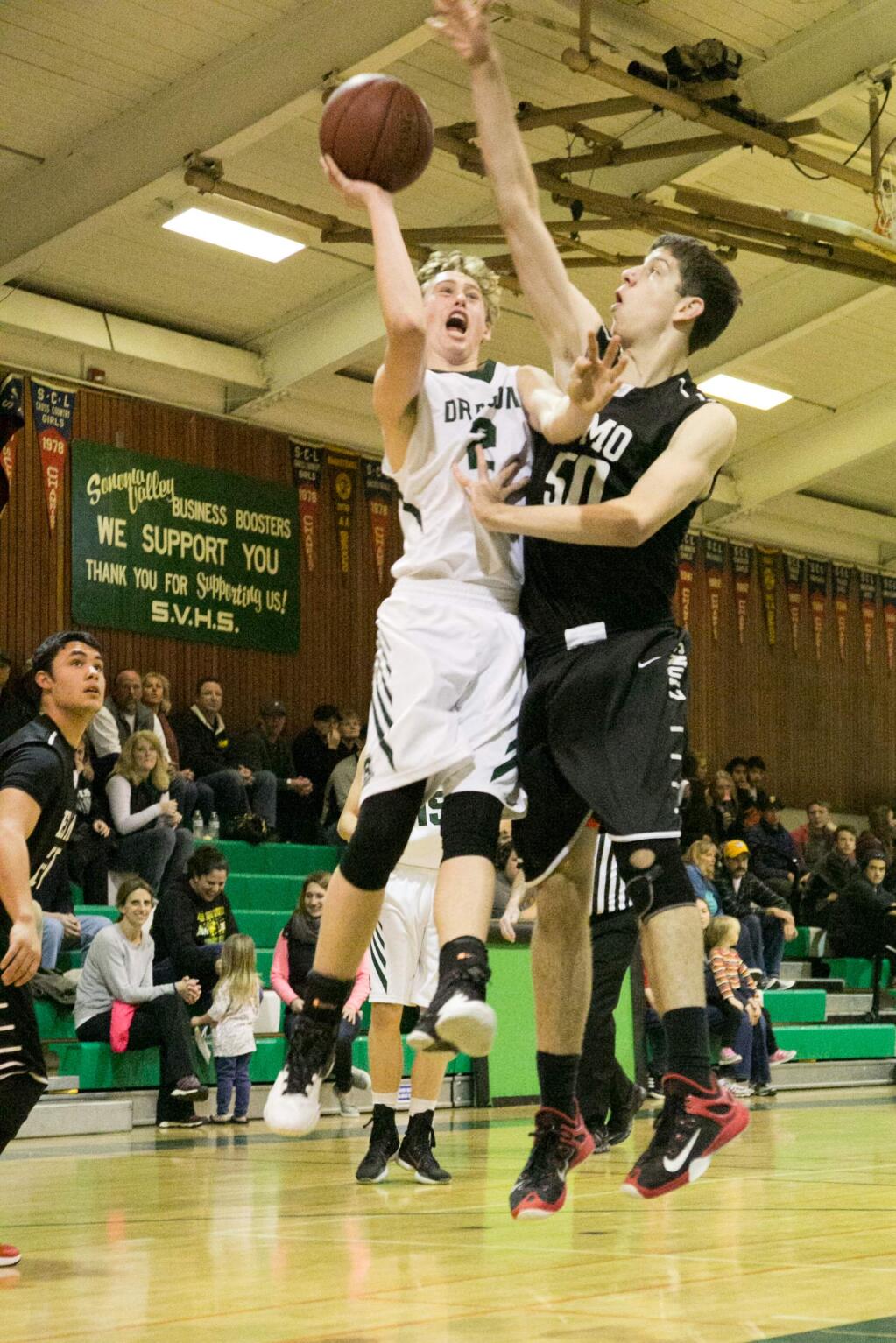 Sonoma's 6-foot 3-inch junior Luke Severson scores first basket against El Molino's 6-foot 7-inch senior Jordan Kireviet. Sonoma led all the way in this home game, won by the Dragons 43-26, Friday night, Feb. 5, 2016. (Photo by Julie Vader/Special to the Index-Tribune)